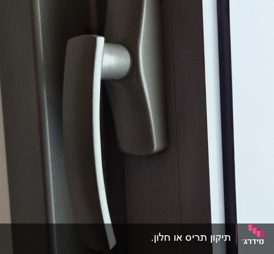 תקריב של ידית ומנגנון נעילה בחלון אלומיניום